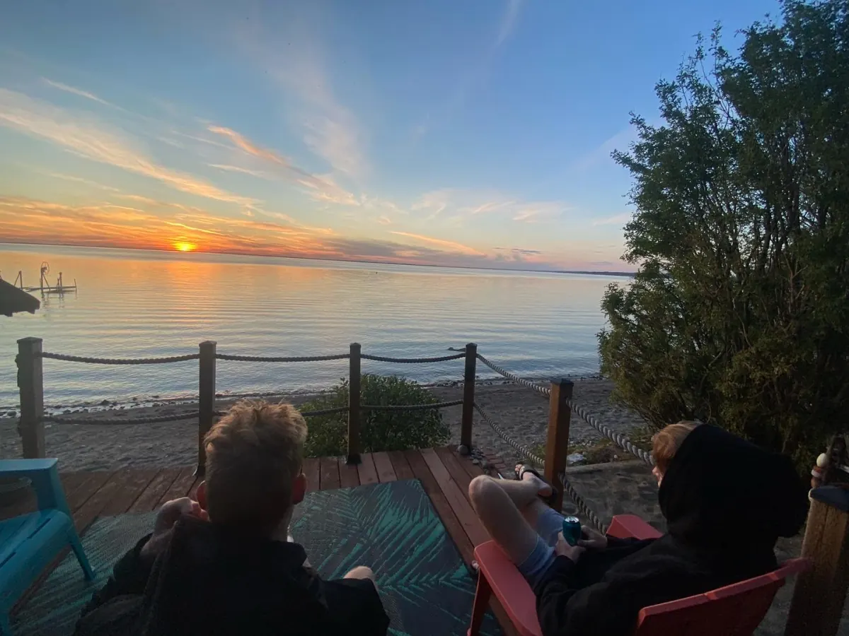 Sunset over Jackfish Lake, Saskatchewan, seen from a lakeside deck